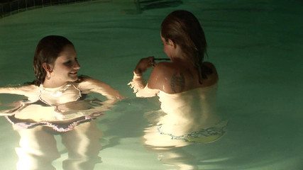 Two hot teens swims naked in the pool