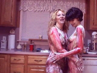 Girls get hot for each other and paint each other's nice tits on kitchen floor