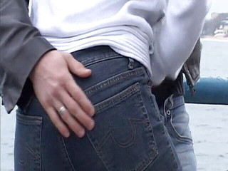 Blonde girl gives a dude handjob outdoors