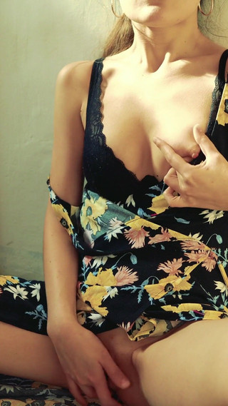 Pretty woman masturbates on camera in a dress and brings herself to a loud orgasm with her fingers.