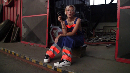 Sweet blonde teen with small tits smokes her cigarette