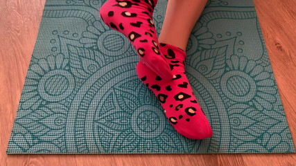Athletic Girl Doing Leg Exercises in Pink Socks on a Yoga Mat