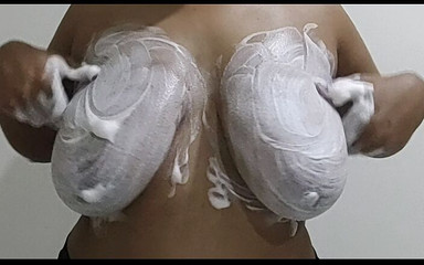 Girls with big boobs rubbing her tits with foam