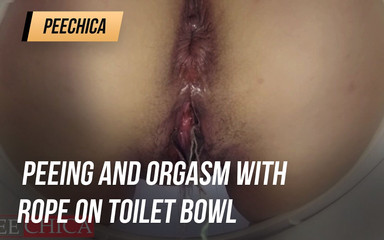 Peeing and orgasm with rope on toilet bowl