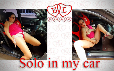 A lady masturbates in a car in a parking lot, teasing a clit with a dildo