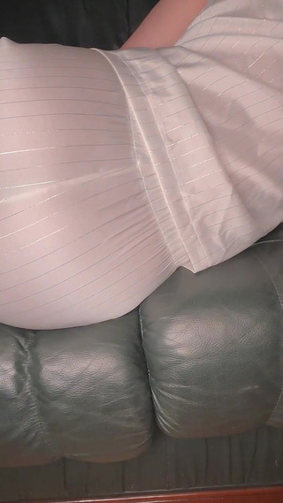 Farting in White Satin Pajama on Green Leather Sofa