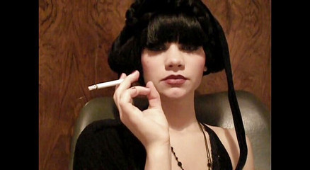 Glamorous beauty smoking a cigarette